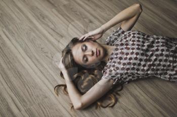 Portrait of a girl with flowing hair lying on the floor.