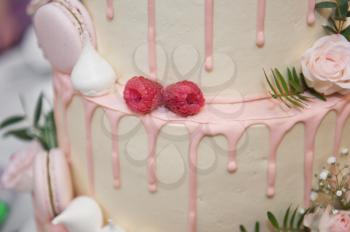 Elegant wedding cake decorated with berries and shells.