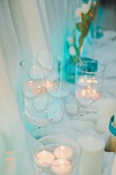 The tiny white roses in glass vases.