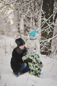 Mother with two children on a winter walk.