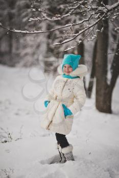 A little girl enjoys the arrival of winter.