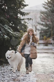 A girl walks on a leash your dog.