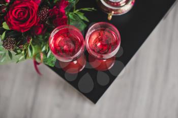 Two glasses with red wine on the table.