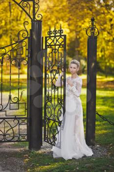 The bride holds the door forged gate.