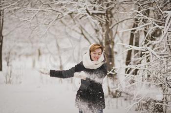 A girl walks in with white frost winter forest.