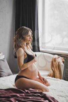 Studio shooting of a woman during pregnancy.