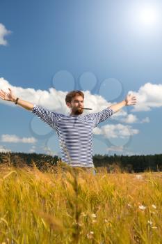 man in a striped vest on the nature in the field of e-cigarette