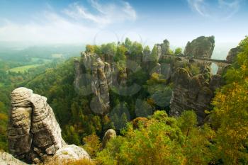 Bridge named Bastei in Saxon Switzerland Germany on a sunny day in autumn with colored trees and leafs