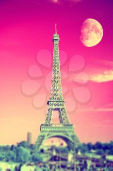 summer evening moon over the Eiffel Tower symbol of Paris. Travel to Europe and France