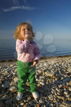 portrait of a little girl on the beach in the summer .