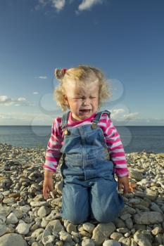 little girl weeping by the sea. summer vacation by the ocean
