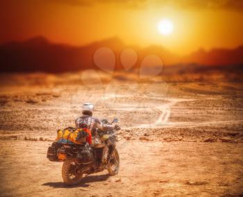 biker in the Atacama travels alone in the desert.