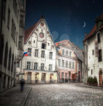 Old streets of European cities. Cozy cottages. Tallinn the capital of Estonia on the Baltic Sea. night shining moon and stars
