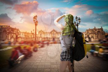 A traveler with a backpack. Panoramic view of Lima main square and cathedral church.