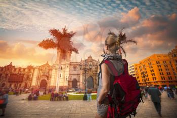 A traveler with a backpack. Panoramic view of Lima main square and cathedral church.