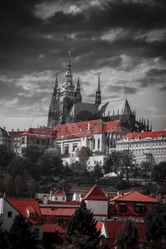 Scenic summer panorama of the Old Town architecture with Vltava river and St.Vitus Cathedral in Prague, Czech Republic. black and white photo with red color.