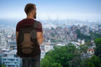 man traveler stands with a backpack on the background of Favel RIO