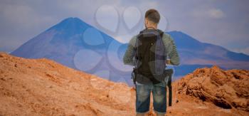 the traveler is standing with a backpack. San Pedro de Atacama, Chile, South America
