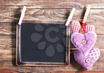 color hearts from textile on wooden background
