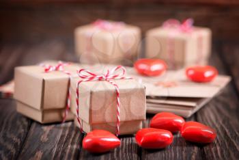 box for present and hearts on the wooden table