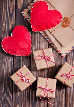 box for present and hearts on the wooden table