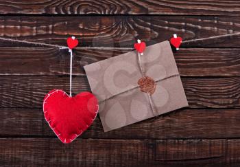 red hearts and envelopes on the wooden table