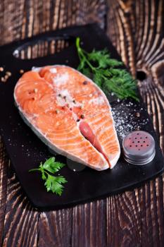 raw salmon with pepper and salt on a table