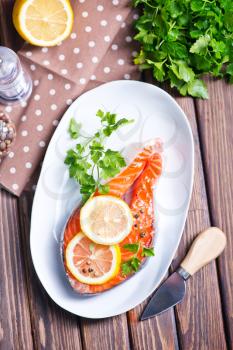 salmon with lemon and pepper on plate