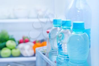 Refrigerator full of food, water in bottles