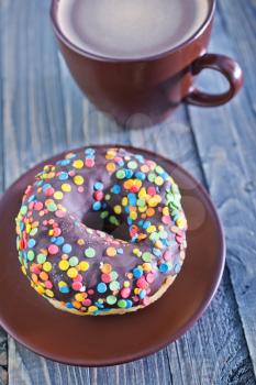 chocolate donuts and coffee in cup on a table