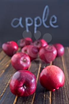 red and big apples on the wooden table