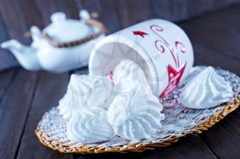 meringues in bowl and on a table
