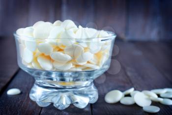 white chocolate in glass bowl and on a table