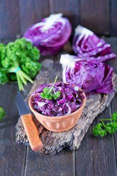 blue cabbage in bowl and on a table