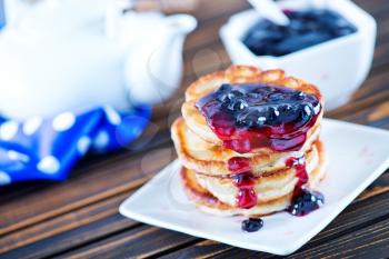 pancakes with jam on plate and on a table