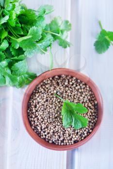 coriander in bowl and on a table
