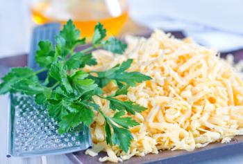 grated cheese  on plate and on a table