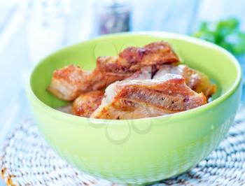 fried meat in bowl and on a table
