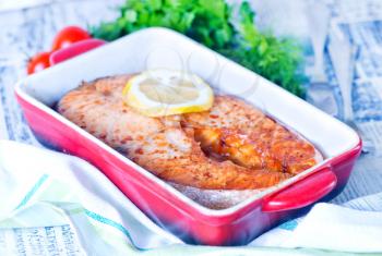 baked salmon and lemon in the red bowl