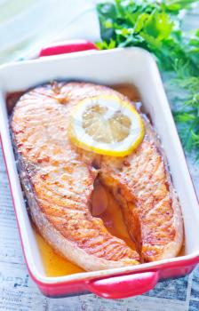 baked salmon and lemon in the red bowl