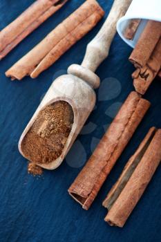 cinnamon in wooden spoon and on a table