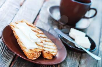 bread with butter and fresh coffee in cup