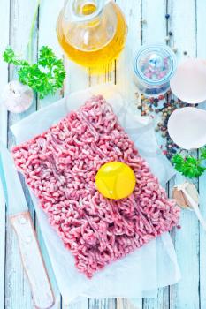 raw minced meat  with spice and salt on a table
