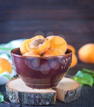 apricot in bowl and on a table