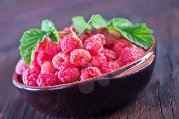 fresh raspberry in bowl and on a table