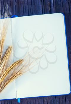 wheat and paper on the wooden background