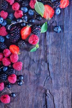 berries on the wooden table, mixed berries
