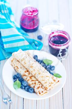 pancakes with fresh berries on the white plate