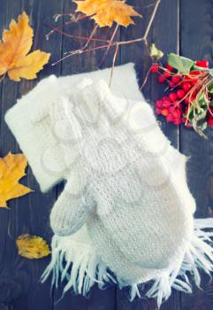 white mittens and scarf on the wooden table