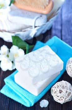 white aroma soap and flowers on a table